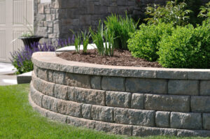 A Picture Of A Retaining Wall That Was Built By Delaware County Landscape And Tree To Hold Back Bushes And Trees